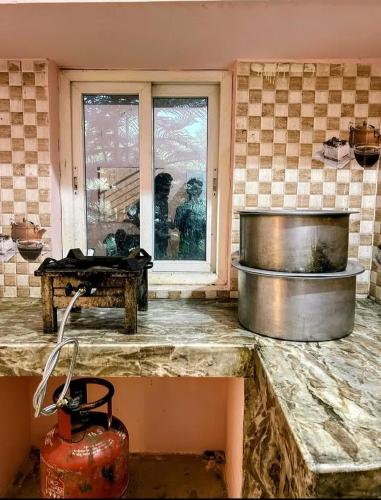 a kitchen with a counter top and a window at Mir's Farm House in Hyderabad