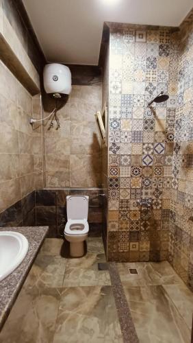 a bathroom with a toilet and a sink at The Palace Dahab in Dahab