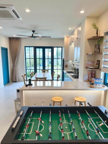 a kitchen with a pool table in the middle of a room at Solara Coast Villa in Tiến Thành