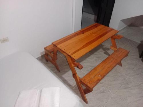 a wooden table sitting on top of a floor at Apartaestudio in Chiquinquirá