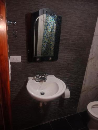 a bathroom with a sink and a mirror at Apartaestudio in Chiquinquirá