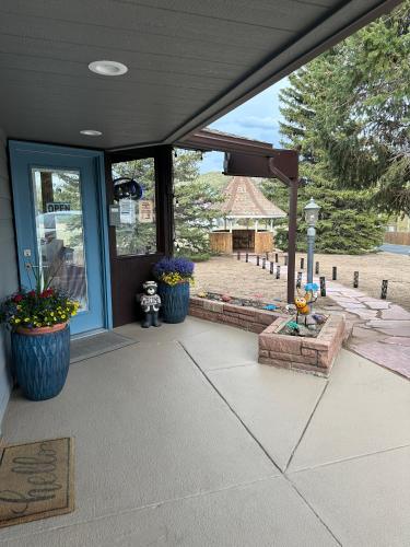 a porch with two large pots of flowers on it at Columbine Inn in Estes Park