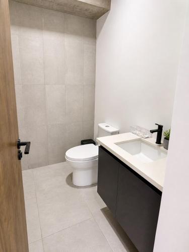 a bathroom with a toilet and a sink at Estudio 905 in San Salvador