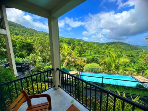 a balcony with a view of a pool and mountains at Grand Hills kandy in Kandy
