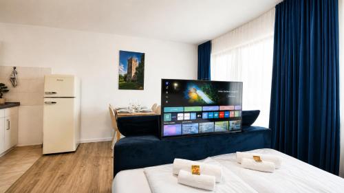 a hotel room with two beds and a flat screen tv at KOMM - Panoramablick - Balkon - Küche - Parkplatz in Suhl
