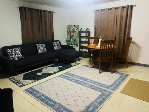 a living room with a couch and a table at Manutapu Lodge in Tongatapu