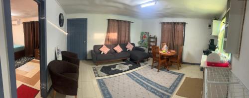 a living room with a couch and a table at Manutapu Lodge in Tongatapu