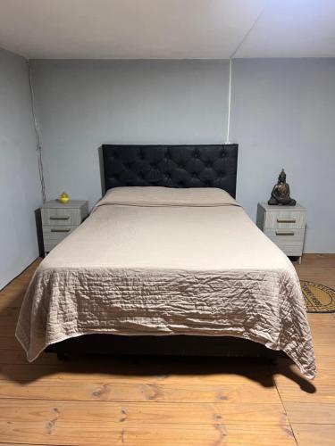a bedroom with a bed and two night stands at La Esperanza in Deán Funes