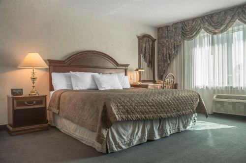 a hotel room with a large bed and a window at Rodeway Inn Fallsview in Niagara Falls
