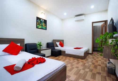 a hotel room with two beds and a living room at Nhà Khách Giao Thông in Hanoi