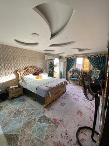 a bedroom with a large bed and a ceiling at Bianki Home in Alexandria