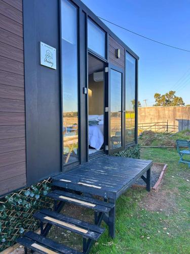 a house with a picnic table in front of it at Ritaville by Tiny Away in Eaton