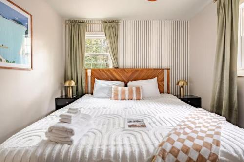 a bedroom with a large white bed with two lamps at Three Trees Retreat in Ellijay