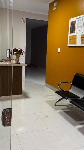 an office with a chair and a yellow wall at Villas hotel in Barreiras