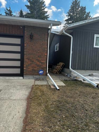 a house with a garage with a garage door at 1500 Sqft Entire Basement Cozy Private Suite in Saskatoon