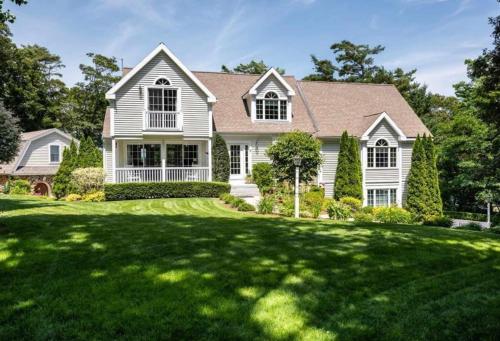 a white house with a large green yard at Buzzards Bay Family Beach Firepit CapeCodCanal in Bourne