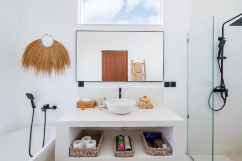 a bathroom with a sink and a shower at Villa Ombak - 1BR Private Luxury Villa 150m from Seseh Beach in Canggu