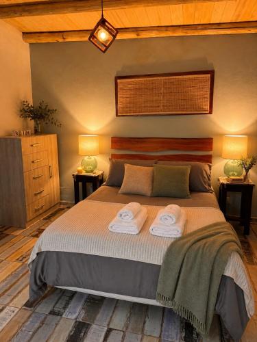 a bedroom with a bed with two towels on it at Ranchos de la Tata in Las Calles