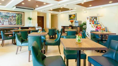 a restaurant with wooden tables and blue chairs at Microtel Inn & Suites by Wyndham San Fernando in San Fernando