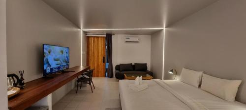 a hotel room with a bed and a living room at Amara Resort Hua Hin in Hua Hin
