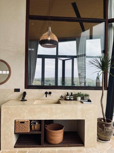 a bathroom with a sink and a large mirror at Lemeraude BnB in Hengchun South Gate
