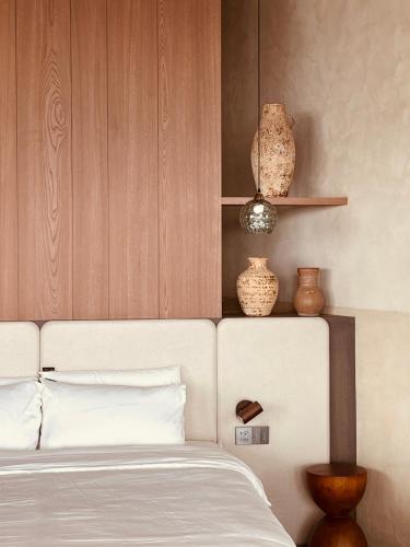 a bedroom with a bed with vases on the wall at Lemeraude BnB in Hengchun South Gate