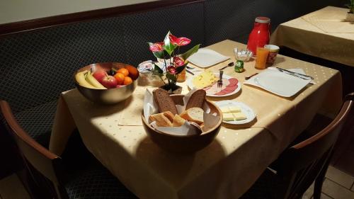 a table with two bowls of bread and fruit on it at Pension Hofer in Bad Berneck im Fichtelgebirge
