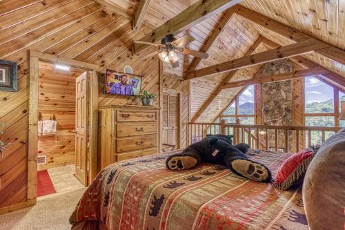 a teddy bear laying on a bed in a cabin at Campfire Lodge in Sevierville