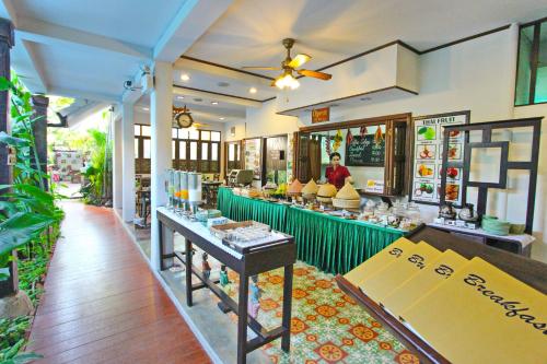 a restaurant with a counter in the middle of a room at Shewe Wana Boutique Hotel in Chiang Mai