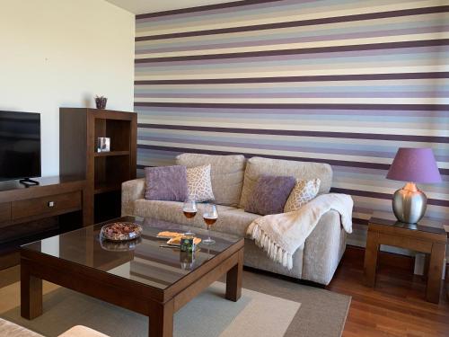 a living room with a couch and a coffee table at CANELAS CLASS con AMPLIAS TERRAZAS in Portonovo