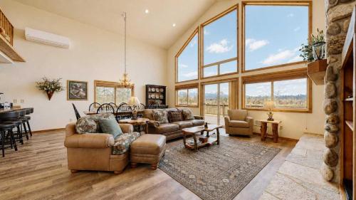 a living room with two couches and a table at Spacious McCall Home Near Golf Course in McCall