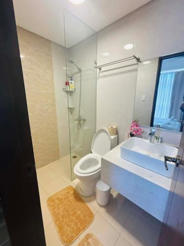 a bathroom with a toilet and a sink and a shower at Ocean Garden Villas Cluster B 3rd Floor Unit C in Boracay