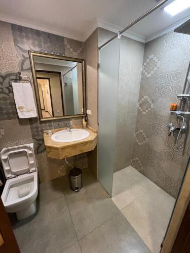 a bathroom with a sink and a toilet at Boulevard Hotel in Yerevan