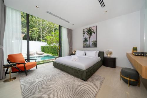 a bedroom with a bed and a swimming pool at Botanica Foresta 4BDR by Villacarte in Ban Phru Champa