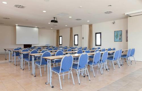 a conference room with tables and chairs and a screen at Impressive Playa Granada Golf in Motril