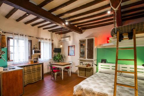 a bedroom with a bunk bed and a kitchen at Diladdarno in Florence