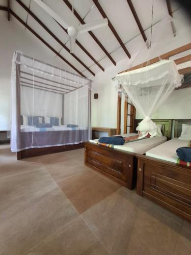a bedroom with two beds and a large window at Jackland Holiday Cabanas in Demanhandiya