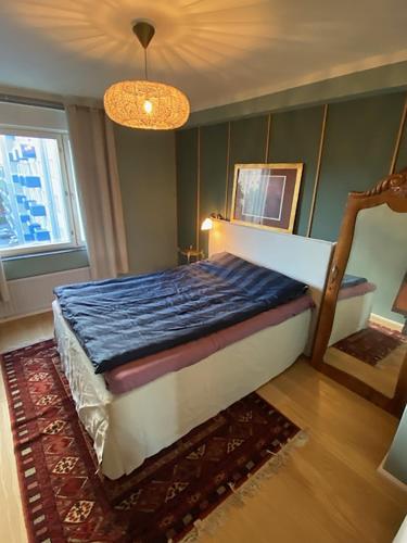 a bedroom with a bed in a room with a window at ArtBeat Downtown in Turku