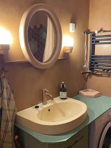 a bathroom with a sink and a mirror at ArtBeat Downtown in Turku