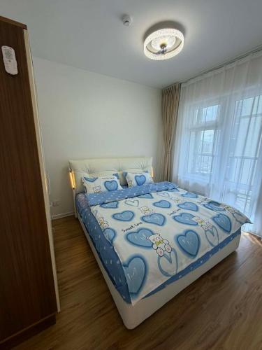 a bedroom with a bed with a blue comforter at Modern Luxury Debut - Untouched in Ulaanbaatar