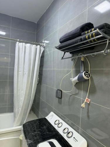 a small bathroom with a stove and a shower at Modern Luxury Debut - Untouched in Ulaanbaatar