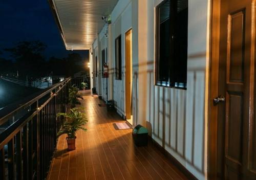 a balcony of a building with plants on it at night at Negradas Transient Inn-with Air-conditioning in Manolo Fortich