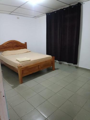 a bedroom with a bed and a black curtain at Casa de Malle in Pocrí