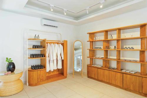 a dressing room with wooden shelves and a mirror at Eri Maldives in North Male Atoll