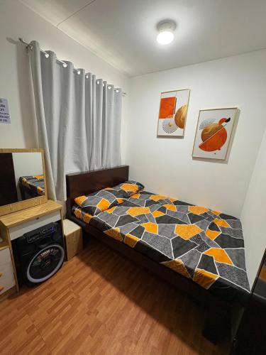 a bedroom with a bed with a quilt on it at Breena & Dhanie's Haven I in Labac