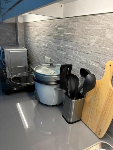 a kitchen counter with a container of cooking utensils at Breena & Dhanie's Haven I in Labac