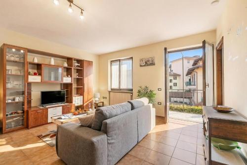 a living room with a couch and a tv at Sunrise in Baveno: Apartment for 4 with Balcony - Happy Rentals in Baveno