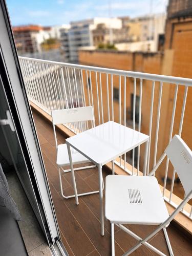 a white table and chairs on a balcony at Msida Modern & Bright 2-Bedroom Apartment in Msida