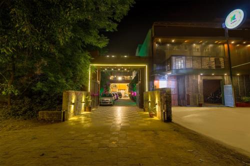 a car is parked outside of a building at night at Treebo Maple Delite in Lucknow
