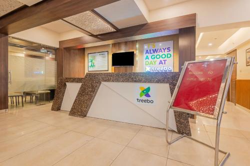 a hotel lobby with a sign that reads its always a good day at melico at Treebo Maple Delite in Lucknow